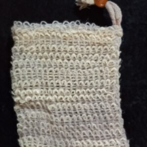 A beige woven bag approximately 3 inches by 4 inches with a drawstring closure