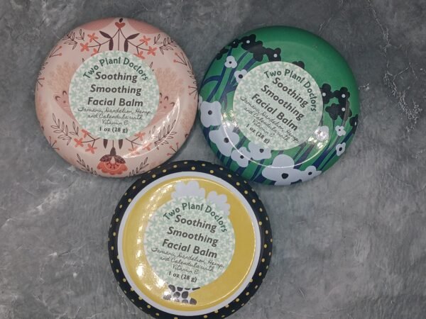 Three round tins of Soothing Smoothing Facial Balm in various colors