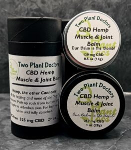 two tins and a cardboard tube of balm