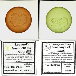 One brown soap with heart and pawprint, and one green soap with heart and pawprint