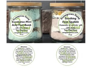 two small glass jars containing colored powders and herbs