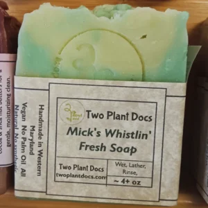 A rectangular green and white Mick's Whistlin' Fresh Soap.
