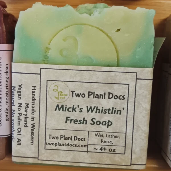A rectangular green and white Mick's Whistlin' Fresh Soap.