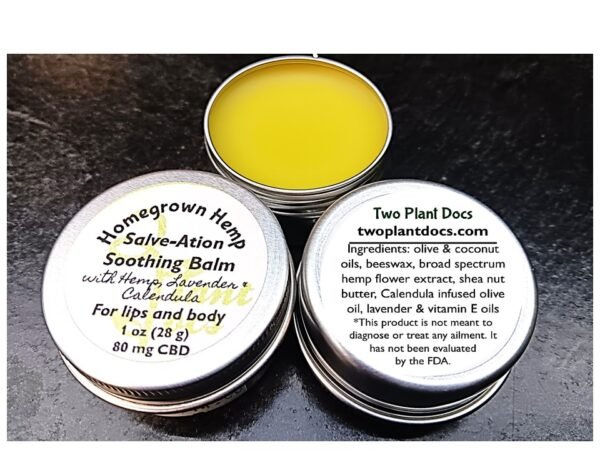 Three round, silver tins. Two with white labels for Salve-Ation Soothing Balm. One with a yellowish balm.