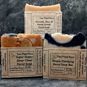 Three square soaps arranged with front showing. One is Avocado, Aloe, and Hemp Gentle Facial Soap. One is Simply Clarifying Facial Soap Bar. One is Super Duper Deep Clean Facial Soap.