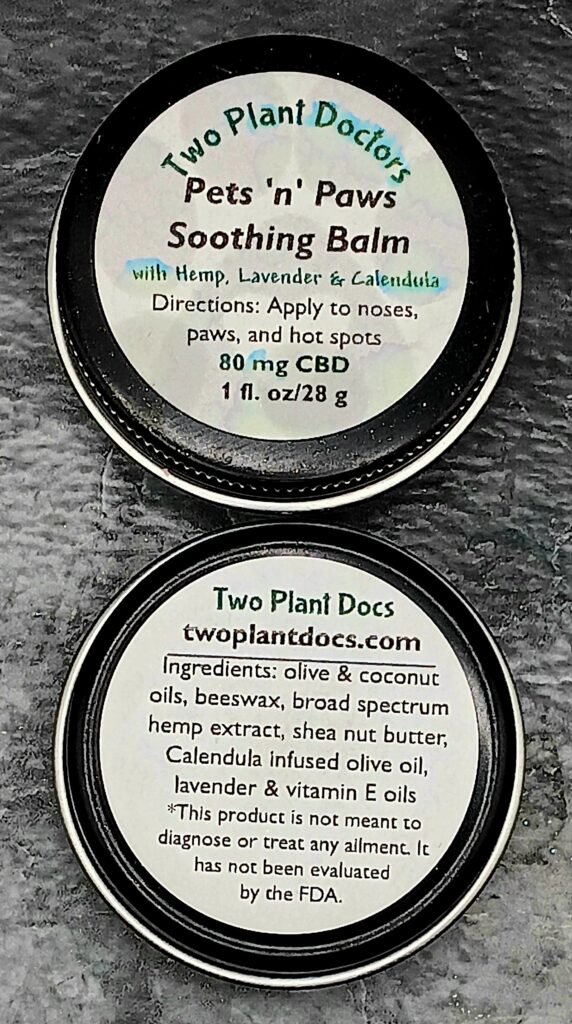 Two round black tins with white labels.