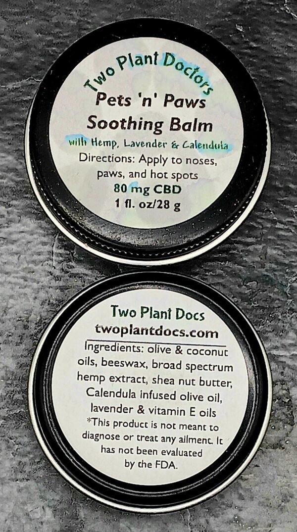 Two round black tins with white labels.