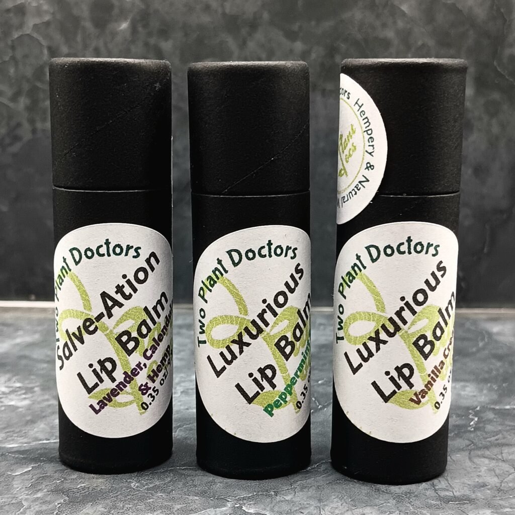 Three black tubes of lip balm