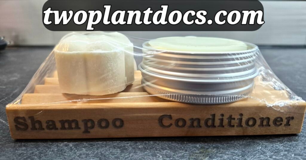 A long wooden soap tray with a flower shaped bar and a round bar in a metal tin